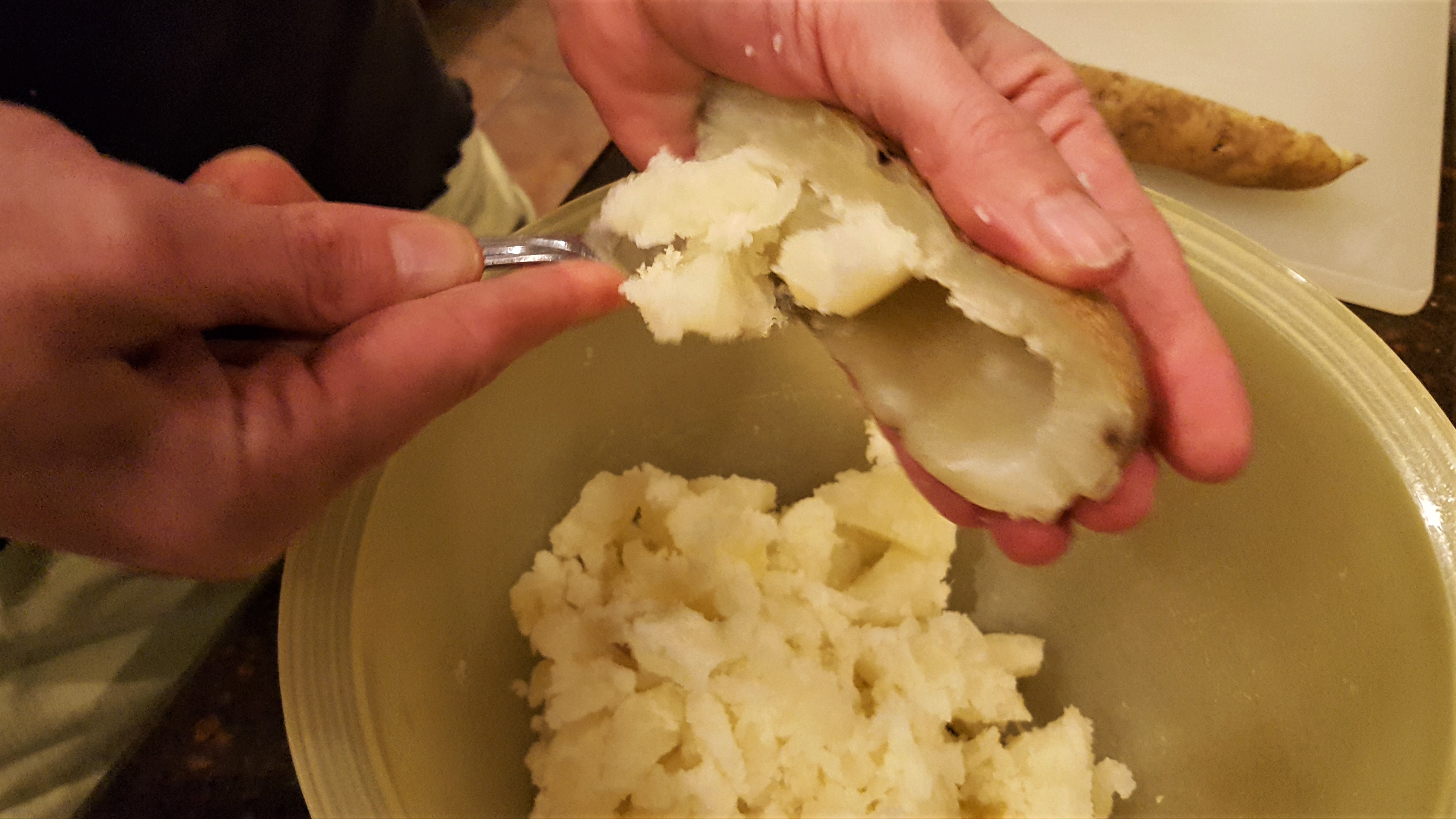 Scooping out Potato meat. Twice Baked Potatoes