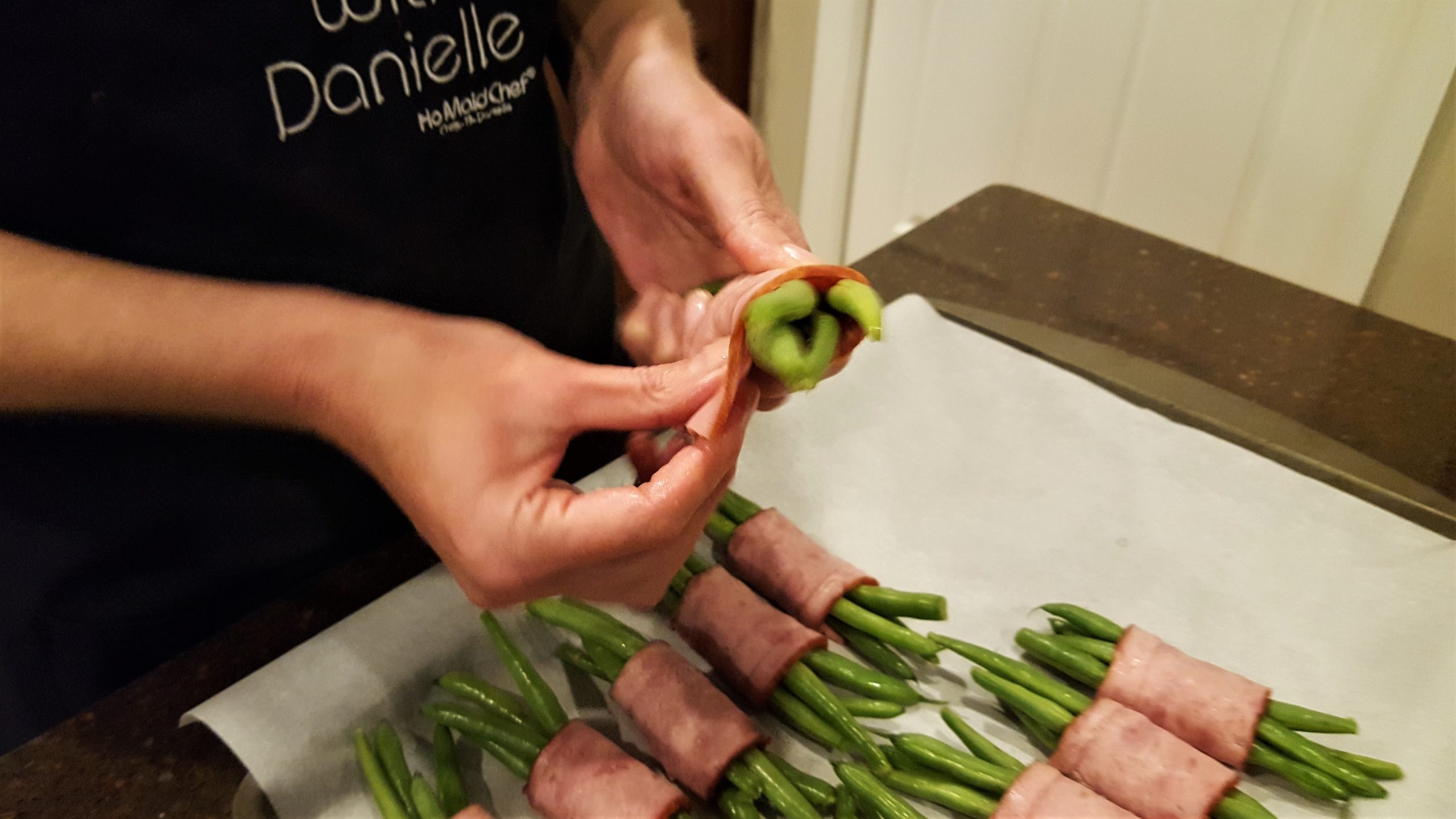 Here we show you how the wrap the turkey bacon around fresh green beans - Dining in with Danielle